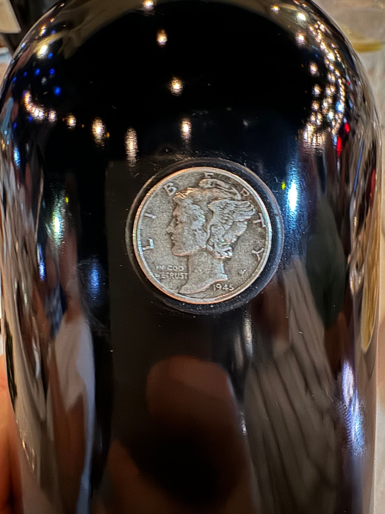 ...with an actual 1945 dime embedded in the bottle lol