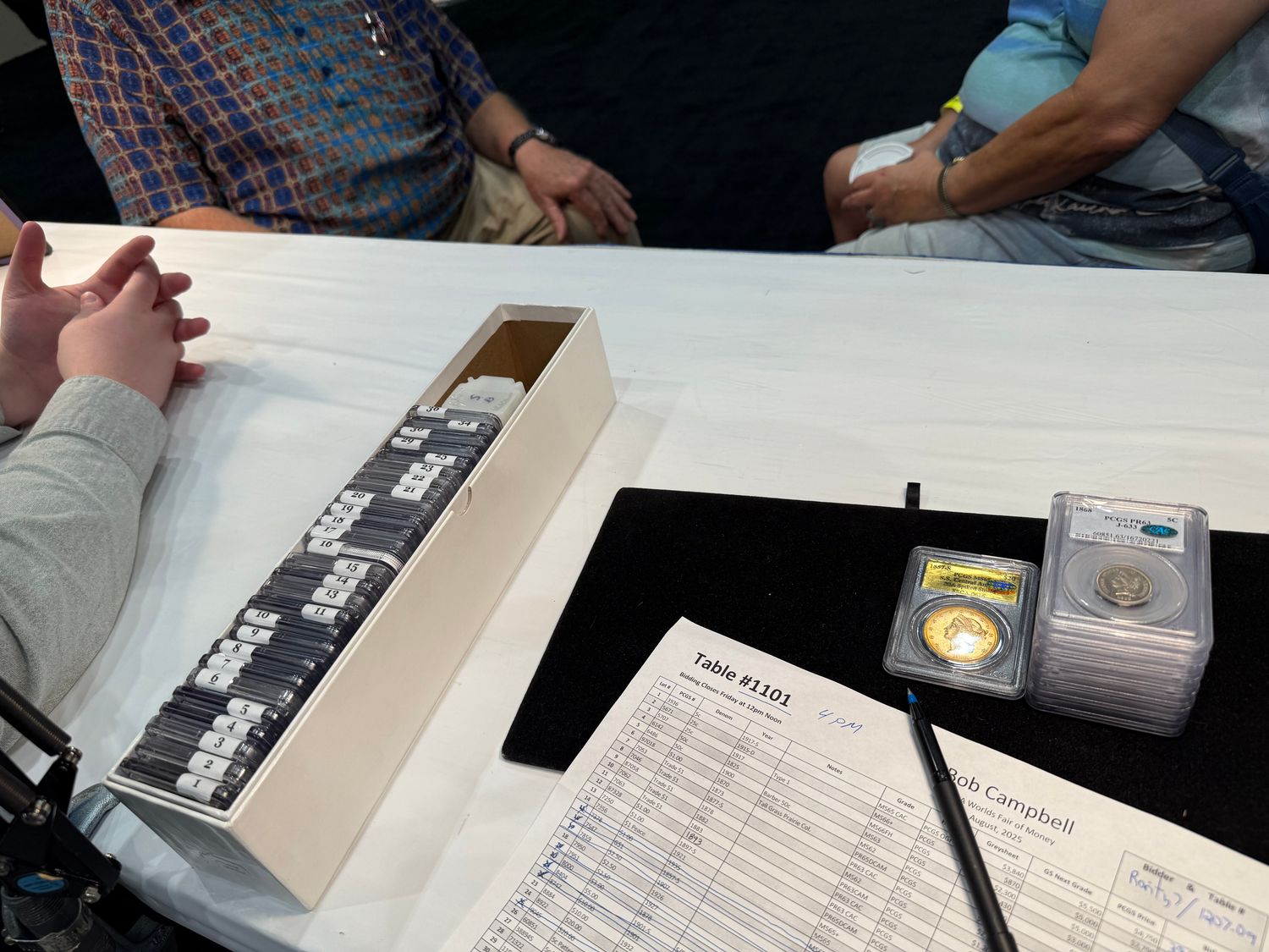 Filling out bids at Bob’s dealer auction